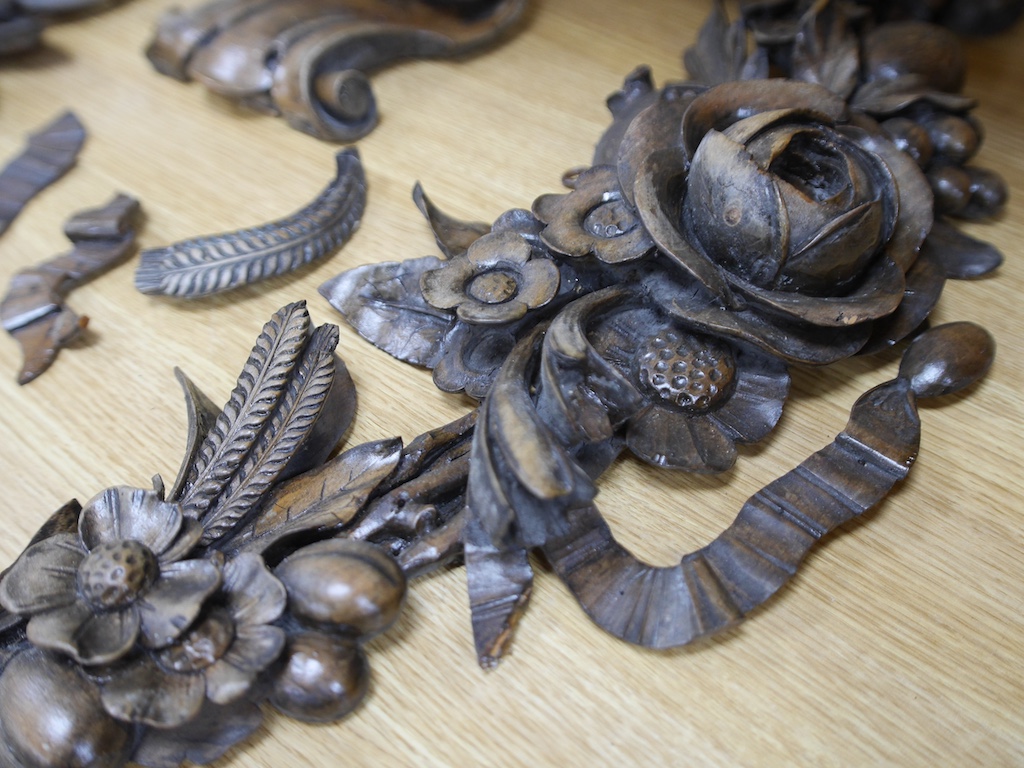 A pair of late 19th/early 20th century carved beech ‘fruit and flower’ wall appliqués and a similar corbel, 70cm long. Condition - fair